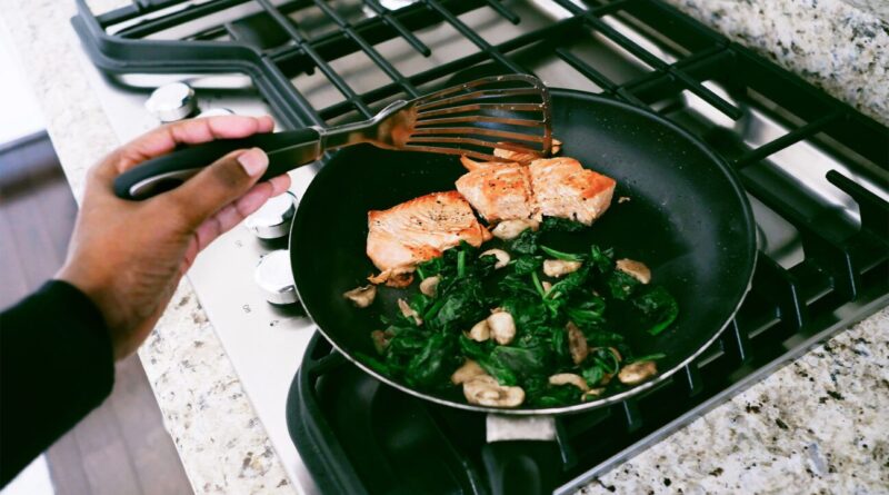 Cooking chicken and vegetables in a pan.