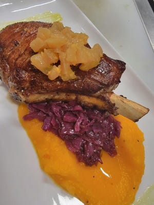 Berkshire pork chop with cider braised red cabbage and roasted candy squash, from Cavé Bistro at Avon-by-the-Sea.